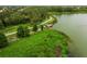 Scenic aerial view of a community walking trail, lake, and a pier, surrounded by lush green landscaping at 224 Dahlia Ct, Bradenton, FL 34212
