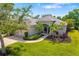An eye-level aerial view of the front exterior of a beautiful single-story home with a lovely manicured front yard at 224 Dahlia Ct, Bradenton, FL 34212