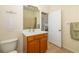 Bright bathroom featuring one sink with wooden cabinet, tile floor, mirror and shower-tub combo at 224 Dahlia Ct, Bradenton, FL 34212