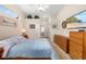 Cozy bedroom with TV, dresser, and closet access; well-lit by natural light at 224 Dahlia Ct, Bradenton, FL 34212