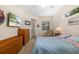Comfortable bedroom with dresser, TV, chair, and access to the outdoors at 224 Dahlia Ct, Bradenton, FL 34212