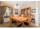 A dining room area featuring wooden furniture, a chandelier, a large window, and neutral paint at 224 Dahlia Ct, Bradenton, FL 34212