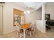 Bright dining room with wood table, shutters, and ample seating near the piano at 224 Dahlia Ct, Bradenton, FL 34212