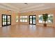 A bright hallway with tile flooring, windows, doors, and a glimpse of the pool outside for community gathering and events at 224 Dahlia Ct, Bradenton, FL 34212