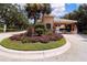 Community entryway featuring a guard house and lush landscaping at 224 Dahlia Ct, Bradenton, FL 34212