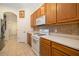 A kitchen area showcasing tile flooring, oak cabinets, white appliances, and white countertops at 224 Dahlia Ct, Bradenton, FL 34212