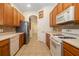 Functional kitchen features stainless steel refrigerator, white appliances, and ample cabinet space at 224 Dahlia Ct, Bradenton, FL 34212