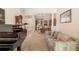 An open-concept space with piano, couch, and view to dining area; lots of space for entertaining at 224 Dahlia Ct, Bradenton, FL 34212