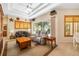 Comfortable living room with tray ceiling, plush seating, and view of the lanai at 224 Dahlia Ct, Bradenton, FL 34212