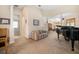 An open-concept space with piano, couch, and view to dining area; lots of space for entertaining at 224 Dahlia Ct, Bradenton, FL 34212