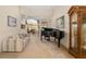 An open-concept space with piano, couch, and view to dining area; lots of space for entertaining at 224 Dahlia Ct, Bradenton, FL 34212