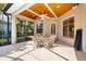 Cozy screened patio with ceiling fan, light colored furniture, and view of the backyard at 224 Dahlia Ct, Bradenton, FL 34212