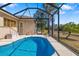Enclosed pool and patio area, with an adjacent yard and beautiful landscaping at 224 Dahlia Ct, Bradenton, FL 34212