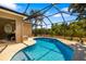 Screened-in pool area featuring a uniquely shaped pool and view of the lawn at 224 Dahlia Ct, Bradenton, FL 34212