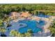 Community clubhouse boasts a beautiful pool area with a splash pad for children, lounge chairs, and covered seating at 224 Dahlia Ct, Bradenton, FL 34212