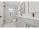 Modern bathroom with a glass shower, double vanity, and sleek black fixtures at 2655 Bay St, Sarasota, FL 34237