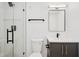 Modern bathroom featuring a glass-enclosed shower, vanity with dark cabinets, and contemporary fixtures at 2655 Bay St, Sarasota, FL 34237