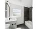 Modern bathroom with a black marble accent wall, new vanity, and sleek fixtures at 2655 Bay St, Sarasota, FL 34237