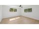 Bright bedroom with hardwood floors, natural light, and a modern ceiling fan at 2655 Bay St, Sarasota, FL 34237