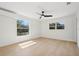 Bright bedroom with hardwood floors and large windows, featuring a ceiling fan at 2655 Bay St, Sarasota, FL 34237