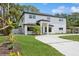 Two-story home with a white exterior, black trim, well-manicured lawn and inviting curb appeal at 2655 Bay St, Sarasota, FL 34237