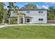 Front exterior of a two-story white home featuring a well-maintained lawn and front yard at 2655 Bay St, Sarasota, FL 34237