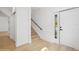 Hallway with hardwood floors, staircase, and white doors, leading to various rooms at 2655 Bay St, Sarasota, FL 34237