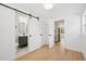 Open interior with a view of the bathroom, kitchen, and living spaces with hardwood floors and modern finishes at 2655 Bay St, Sarasota, FL 34237
