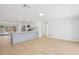 Open-concept kitchen and living area featuring sleek countertops, modern appliances, and wood flooring at 2655 Bay St, Sarasota, FL 34237