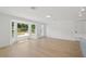 Bright living area featuring a large bay window, wood floors, and a modern design at 2655 Bay St, Sarasota, FL 34237