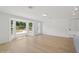 Bright living area featuring hardwood floors, a bay window, and white walls at 2655 Bay St, Sarasota, FL 34237