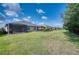 Expansive backyard with a row of screened patios and lush green grass at 2945 Trustee Ave, Sarasota, FL 34243