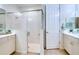 Bathroom with a glass enclosed shower, double sink vanity, and a neutral color scheme at 2945 Trustee Ave, Sarasota, FL 34243