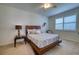 Cozy bedroom with carpet, a wooden bed frame, decorative pillows and neutral-toned walls at 2945 Trustee Ave, Sarasota, FL 34243