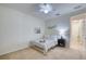 Bright bedroom with a bed, neutral walls, ceiling fan, and a view into the adjacent hallway at 2945 Trustee Ave, Sarasota, FL 34243