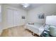Bright bedroom with light walls, carpet, ceiling fan, and closet at 2945 Trustee Ave, Sarasota, FL 34243