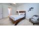 Inviting bedroom featuring a wood bed frame, patterned bedding, and stylish wall decor at 2945 Trustee Ave, Sarasota, FL 34243