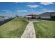 Community common area featuring picnic seating, a table umbrella, and manicured grass at 2945 Trustee Ave, Sarasota, FL 34243