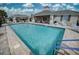 A community pool area featuring plentiful seating, covered areas, and a swimming pool at 2945 Trustee Ave, Sarasota, FL 34243