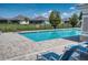 Community pool featuring seating, calming water, safety equipment, and privacy fencing at 2945 Trustee Ave, Sarasota, FL 34243