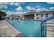 Community pool area featuring plentiful seating, covered areas, and crystal-clear swimming pool at 2945 Trustee Ave, Sarasota, FL 34243