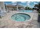 Community pool featuring a hot tub, ample seating, and well-kept decking at 2945 Trustee Ave, Sarasota, FL 34243
