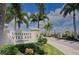 Entrance to University Village, a Medallion Community, with lush landscaping and a stone sign at 2945 Trustee Ave, Sarasota, FL 34243