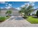 Charming single-story home featuring a paver driveway, two-car garage, and well-maintained landscaping at 2945 Trustee Ave, Sarasota, FL 34243