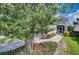 Home exterior showcasing mature landscaping, brick paver driveway, and covered front entry at 2945 Trustee Ave, Sarasota, FL 34243