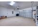 Spacious garage with epoxy flooring, a garage door opener, and ample storage space at 2945 Trustee Ave, Sarasota, FL 34243