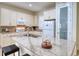 Bright kitchen with granite countertops, stainless appliances, and ample cabinet space at 2945 Trustee Ave, Sarasota, FL 34243