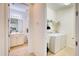 Hallway view to the bathroom and laundry area with white washer and dryer at 2945 Trustee Ave, Sarasota, FL 34243