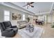 Spacious living area with tray ceiling, ceiling fan, and neutral color scheme with an open concept at 2945 Trustee Ave, Sarasota, FL 34243