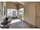 Charming covered patio with brick flooring, outdoor seating, and an arched entryway at 2945 Trustee Ave, Sarasota, FL 34243